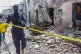 A member of security forces cordons off wreckage at the scen
