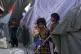 An girl poses for photograph as she takes refuge after her h