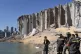 A rescue team surveys the site of a massive explosion in the