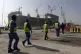 Workers walk to the Lusail Stadium, one of the 2022 World Cu