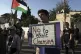 The Palestinian flag is raised at a demonstration by Israeli