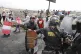 A police officer tries to take away a makeshift shield from 