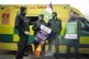 Ambulance workers keep warm around a brazier as they stand o