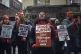 Nurses shout slogans and hold signs during a nursing strike 
