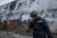 A Ukrainian State Emergency Service firefighter smokes as he