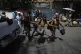 Children run towards their parents at the end of their schoo