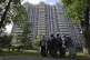 People look at a the apartment building in Moscow, Russia, d