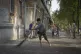 DESTRUCTION: Local residents clean the street from broken gl