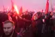 People hold flares as they take part in a yearly march on Po