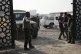 Members of an Iraqi Shiite militant group stand outside the 