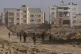 Israeli soldiers walk through the destroyed Khan Younis, Gaz