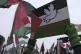 Protesters wave flags and banners outside the International 