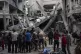 Palestinians inspect the damage to residential buildings cau