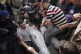 Palestinians react next to the bodies of their relatives who