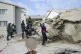 Rescue workers search the site of a building collapse in Geo