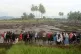 People inspect an area affected by the flash flood that kill