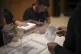 A voter prepares to cast his ballot for Catalonia's regional