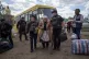 Rescue workers help Liudmila Kalashnik, 88, after evacuation