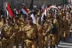 Houthi supporters march marking the anniversary of Yemeni un