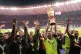 Leverkusen's goalkeeper Lukas Hradecky lifts the trophy afte
