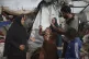 Displaced Palestinians inspect their tents destroyed by Isra