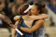 France's Alize Cornet (left) and China's Zheng Qinwen hug af