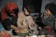 Afghan children eat in a makeshift shelter after an earthqua
