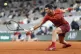 Serbia's Novak Djokovic plays a shot against Italy's Lorenzo