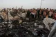 Palestinians look at the destruction after an Israeli strike
