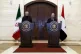Syrian Foreign Minister Faisal Mekdad (right) speaks during 
