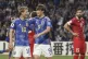 Japan’s Ayase Ueda (centre) is celebrated by teammate Rits