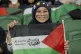 A supporter of Palestine soccer team smiles ahead of their W