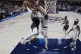 Dallas Mavericks centre Daniel Gafford, left, drives to the 