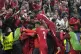 Turkey's Kerem Akturkoglu, covered by his teammates, celebra