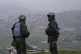 Spanish U.N. peacekeepers stand on a hill overlooking the Le
