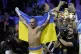 Ukraine's Oleksandr Usyk celebrates after beating Britain's 