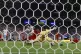 Uruguay's Maximiliano Araujo (centre) (20), scores his side'