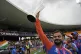 India's Virat Kohli carries the winners' trophy as he celebr