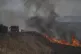 Firefighters work to extinguish a fire following an attack f