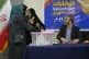 Iranian citizens wait in queue to cast their votes during th