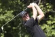 Third-round leader Davis Thompson watches his tee shot on th