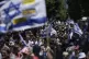 Demonstrators march with Israeli flags during a protest mark