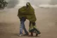 Somali refugee children cover themselves as a dust storm mov