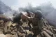 Police officers extinguish a fire after a Russian air strike