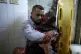 A Palestinian man holds the body of his child killed in an I