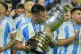 Argentina's Lautaro Martinez kisses the trophy after beating
