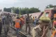 Police and rescuers arrive at the site of a passenger train 