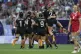 New Zealand team members celebrate after winning the women's