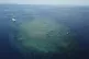 A boat sits above a section of the Great Barrier Reef above 