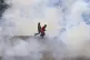 Protestors run through clouds of tears during anti-governmen
